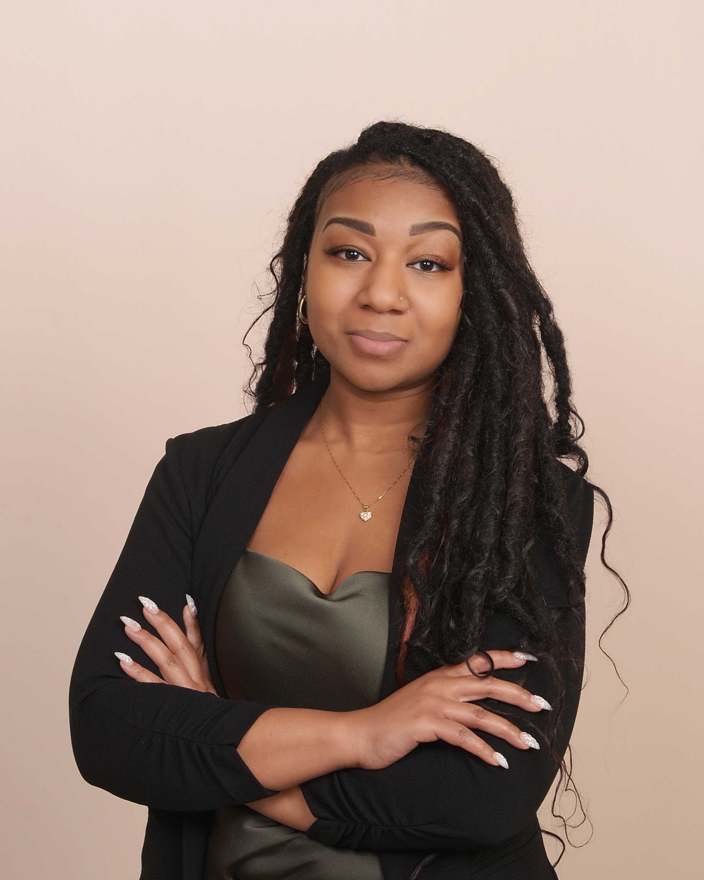 Kendy Jean-Louis, Pennsylvania notary public, with arms crossed in professional attire